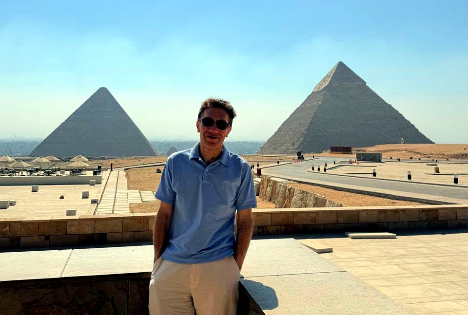 Khaled Nabil Salama standing between the pyramids at Giza